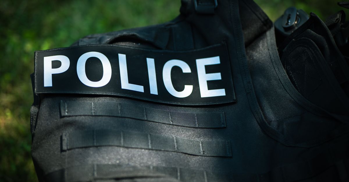Detailed shot of a police vest lying outdoors, highlighting law enforcement gear.
